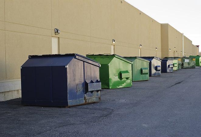 a group of dumpsters lined up along the street ready for use in a large-scale construction project in Alpharetta, GA